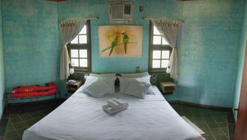 a bedroom with a bed with two towels on it at Hotel Mosteiro - Retiro e Recolhimento in Brotas