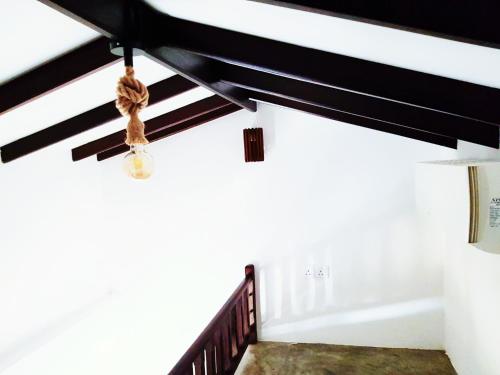 a staircase with black and white walls and a ceiling at Light Moon Villa in Ahangama