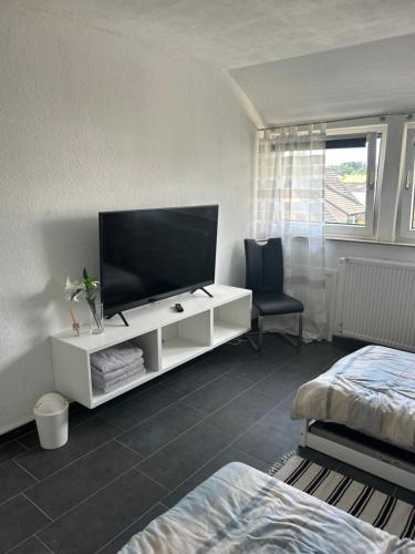een woonkamer met een televisie op een witte kast bij Schöner Wohnen in Bünde in Bünde