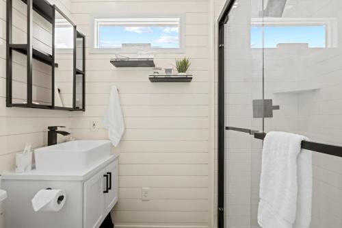 a bathroom with a sink and a shower at New The Yellow Beacon-Luxury Shipping Container in Fredericksburg