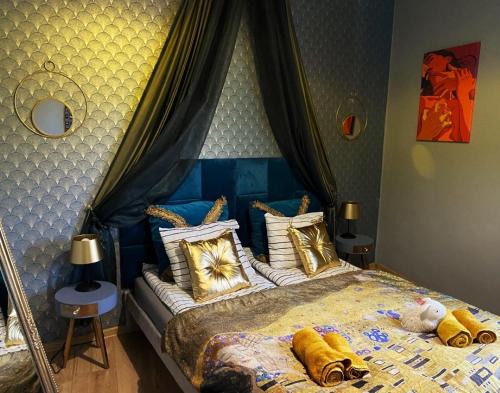 a bedroom with a bed with a blue canopy at Gold room in Krakow