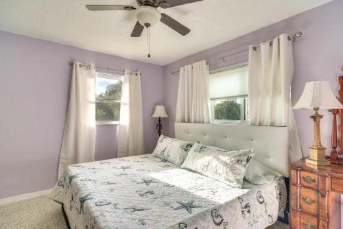 a bedroom with a bed and a ceiling fan at 4 Mi to Dog Beach Largo Home with Pool and Hot Tub! in Largo