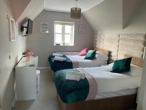 a bedroom with two beds and a window at Weekly & Monthly Rates! Stunning Home By Stansted Airport in Bishops Stortford