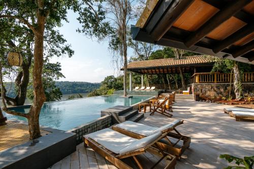 a pool with chaise lounge chairs and a resort at Loi Suites Iguazu Hotel in Puerto Iguazú
