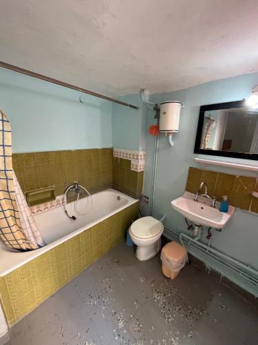 a bathroom with a tub and a toilet and a sink at Traditional Lemon House near to Pireaus Port in Piraeus