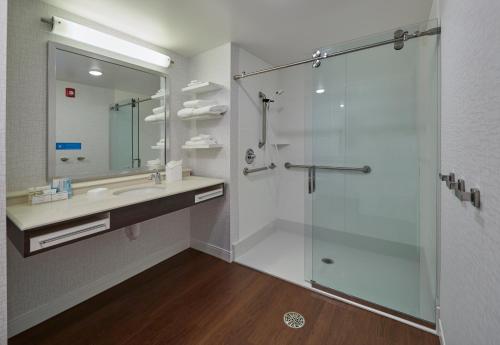 a bathroom with a glass shower and a sink at Hampton Inn & Suites Hood River in Hood River