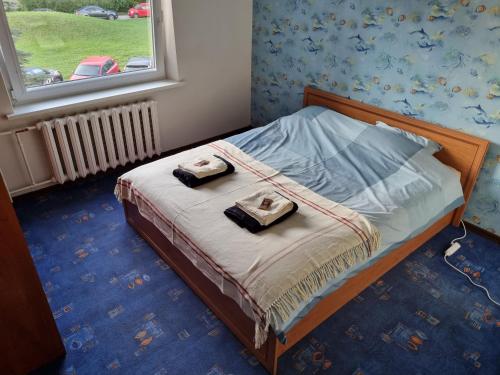 a bedroom with a bed with two towels on it at Eva's apartments in Kaunas