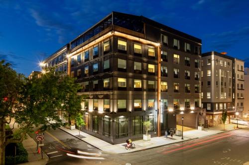 a tall building on a city street at night at The Blake Hotel in New Haven