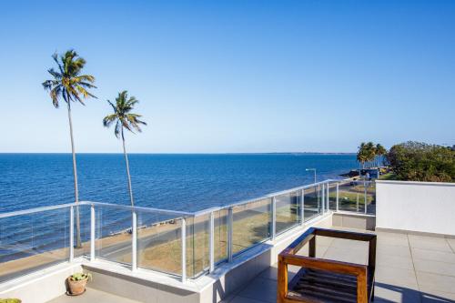 a balcony with a view of the ocean at Cowork Lab Suites in Maputo