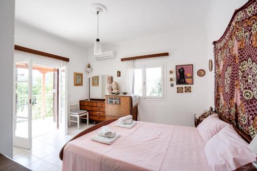 a bedroom with a large bed with white sheets at Greek Village house Peloponnese Sea&Mountain in Aigio