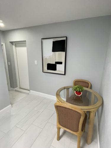 a dining room with a glass table and two chairs at Villa Sosa in Fort Myers
