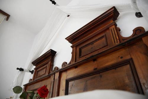 a wooden door with a rose on top of it at Parkhotel Sole Paradiso in San Candido