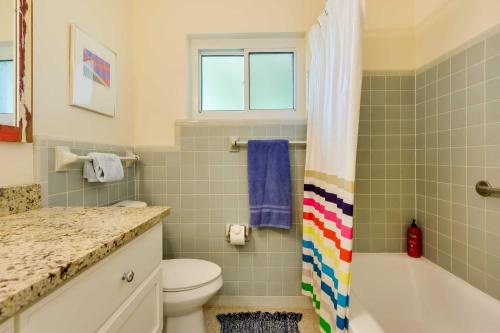 a bathroom with a toilet and a tub and a sink at Uncle Louies Gulf Coast Retreat with Outdoor Oasis! in Bradenton
