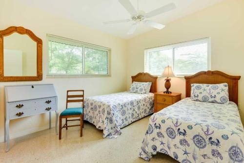 a bedroom with two beds and a mirror and a chair at Uncle Louies Gulf Coast Retreat with Outdoor Oasis! in Bradenton