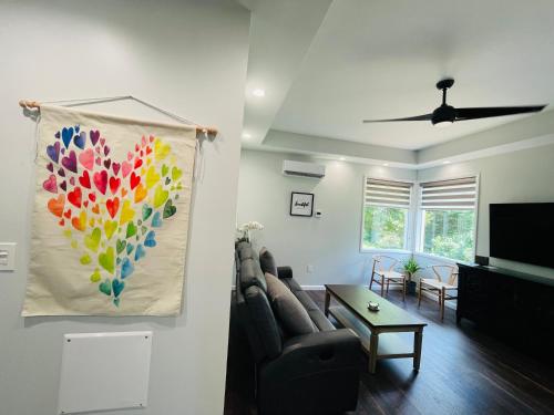 a living room with a couch and a painting on the wall at Sonsak - Unit 2 in Charlottesville