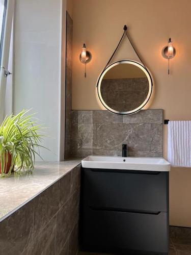 a bathroom with a sink and a mirror at Luxury Victorian spacious flat in Glasgow