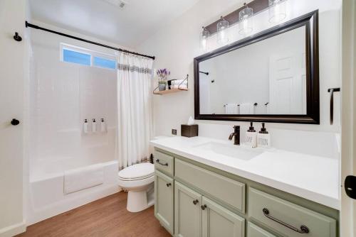 a bathroom with a sink and a toilet and a mirror at Pine Den Cabin: Arcade+Fire Pit+BBQ in Sugarloaf
