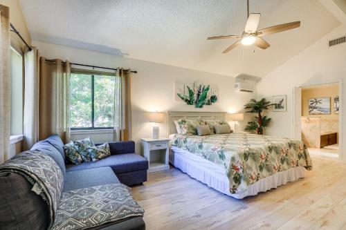 a bedroom with a bed and a couch at Private Saltwater Pool Stunning Seminole Stay! in Redington Shores
