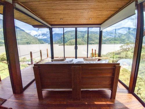 a large room with a tub with a view of a lake at Summer C in Macanal
