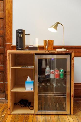 a desk with a glass door and a lamp on top at Fire Station One Boutique Hotel in Roanoke