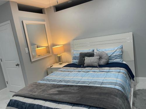 a bedroom with a bed with blue and white sheets at Villa Sosa in Fort Myers