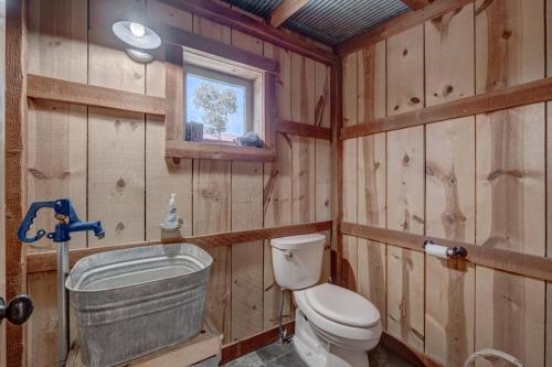 a wooden bathroom with a toilet and a sink at Holy Terror Chalet At Terry Peak Ski Resort in Lead