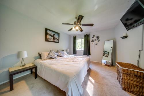 a bedroom with a bed and a ceiling fan at Richmond Heights Retreat with Patio and Fire Pit! in Richmond Heights