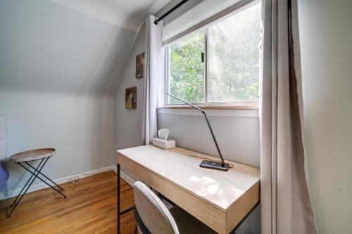 a desk with a lamp on it next to a window at Richmond Heights Retreat with Patio and Fire Pit! in Richmond Heights
