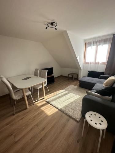 a living room with a couch and a table at Studio cabine chaleureux in Corrençon-en-Vercors