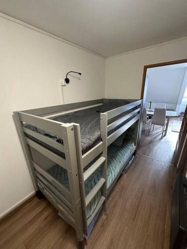 an empty bunk bed in a room with a mirror at Studio cabine chaleureux in Corrençon-en-Vercors