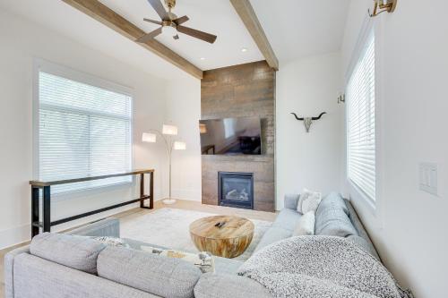 a living room with a couch and a fireplace at Modern Lawrence Home with Patio Less Than Half-Mi to U of K! in Lawrence