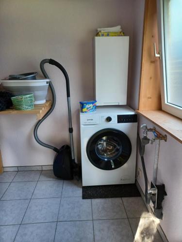 a washing machine in a kitchen with a refrigerator at Ferienhaus Elbliebe - kleine Hunde bis 25 cm willkommen in Dannenberg