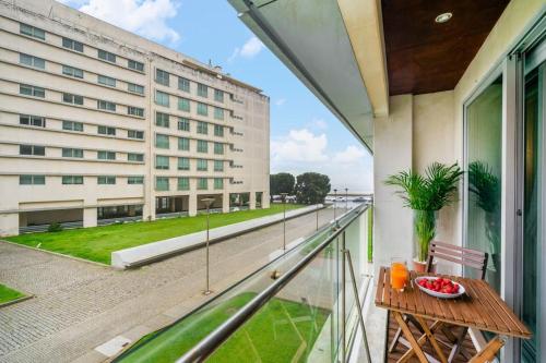 a balcony with a table and a building at Ocean Front 2bed Luxury w/ Elevator Parking WI-FI in Matosinhos