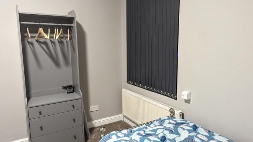 a bedroom with a bed and a dresser and a mirror at 2 Bed Property Close to Centre Trenth Stay in Belle Isle