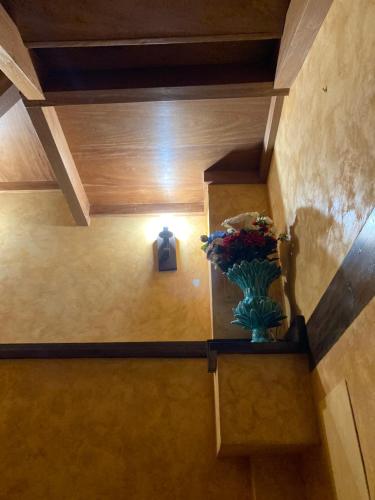 a room with a vase on a shelf with a cross at La Casa de Fefita (Stone house in a privileged environment 35 km from Bilbao) in Villanueva de Mena