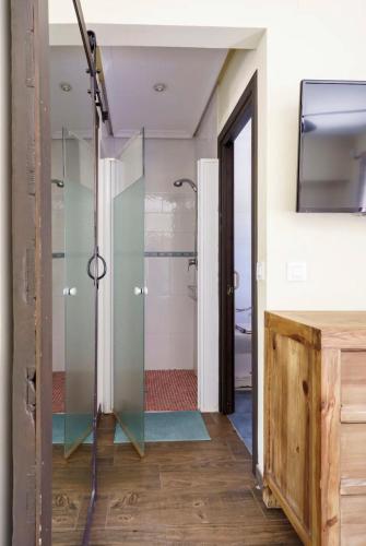 a glass shower in a bathroom with a sink at Finca LaGloria in Guadarrama