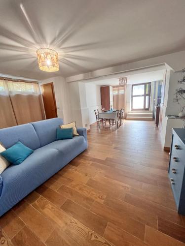a living room with a blue couch and a table at Le dimore di Maria in Manfredonia
