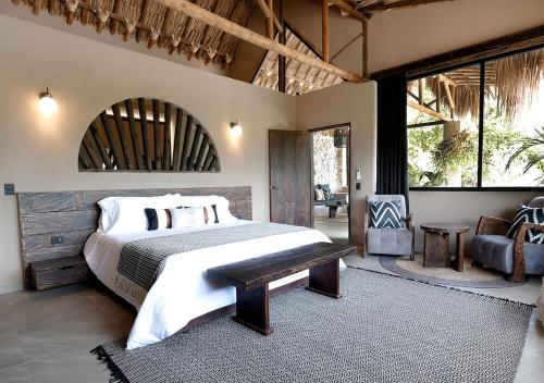 a bedroom with a large bed in a room with windows at Casa Candela in San Jerónimo