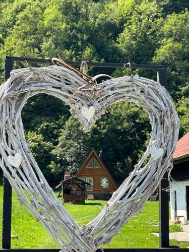 a heart made out of metal in a field at Cabanutze Satic in Rucăr