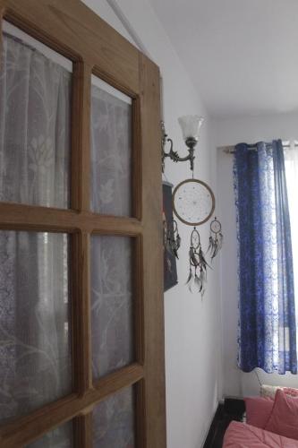 a door to a room with a window and a couch at Mansarover Home Stay in Kalimpong