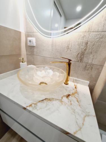a bathroom with a marble sink and a mirror at INFINITY VIEW in Playa del Aguila