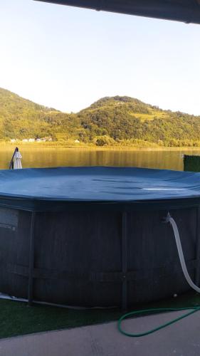 a blue table with a hose on the side of a lake at Kuća za odmor Drina in Zvornik