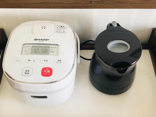 a blender sitting on a counter next to a timer at City Inn Kokura - Vacation STAY 12140 in Kitakyushu