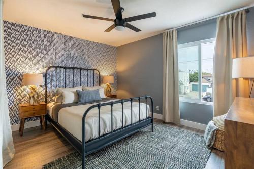 a bedroom with a bed and a ceiling fan at PORCHLIGHT HOME Central San Diego FREE parking in San Diego