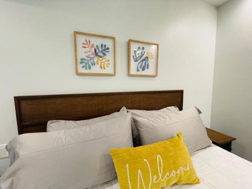 a bedroom with a bed with two pictures on the wall at Sonsak - Unit 3 in Charlottesville