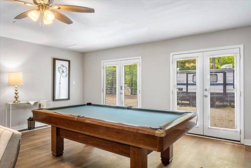 a pool table in a living room with a ceiling fan at Modern Comforts, Classic Charm: Neighborhood Gem in Richmond