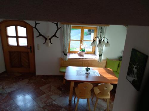 a dining room with a table and chairs and a window at Eisl in Gmunden