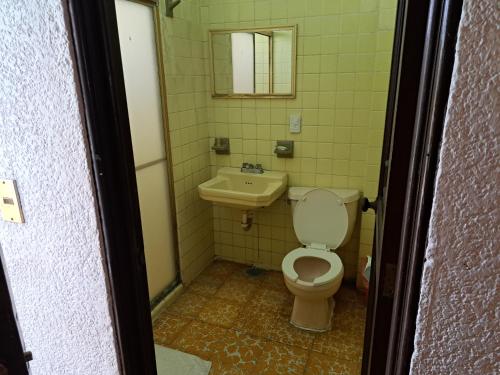 a bathroom with a toilet and a sink at Hotel Playa Azul in Playa Azul