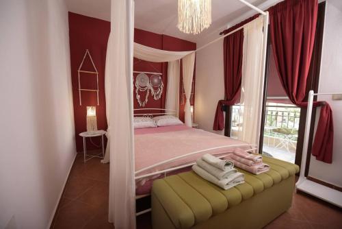 a bedroom with a canopy bed and a yellow stool at AMALFI luxury APARTMENT in Komotini