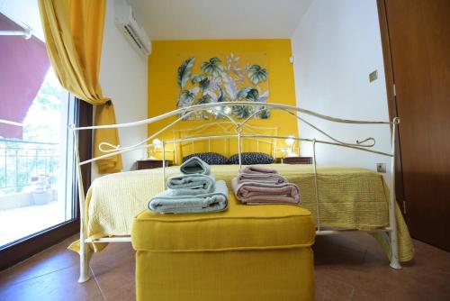 a yellow bedroom with a bed with a yellow wall at AMALFI luxury APARTMENT in Komotini